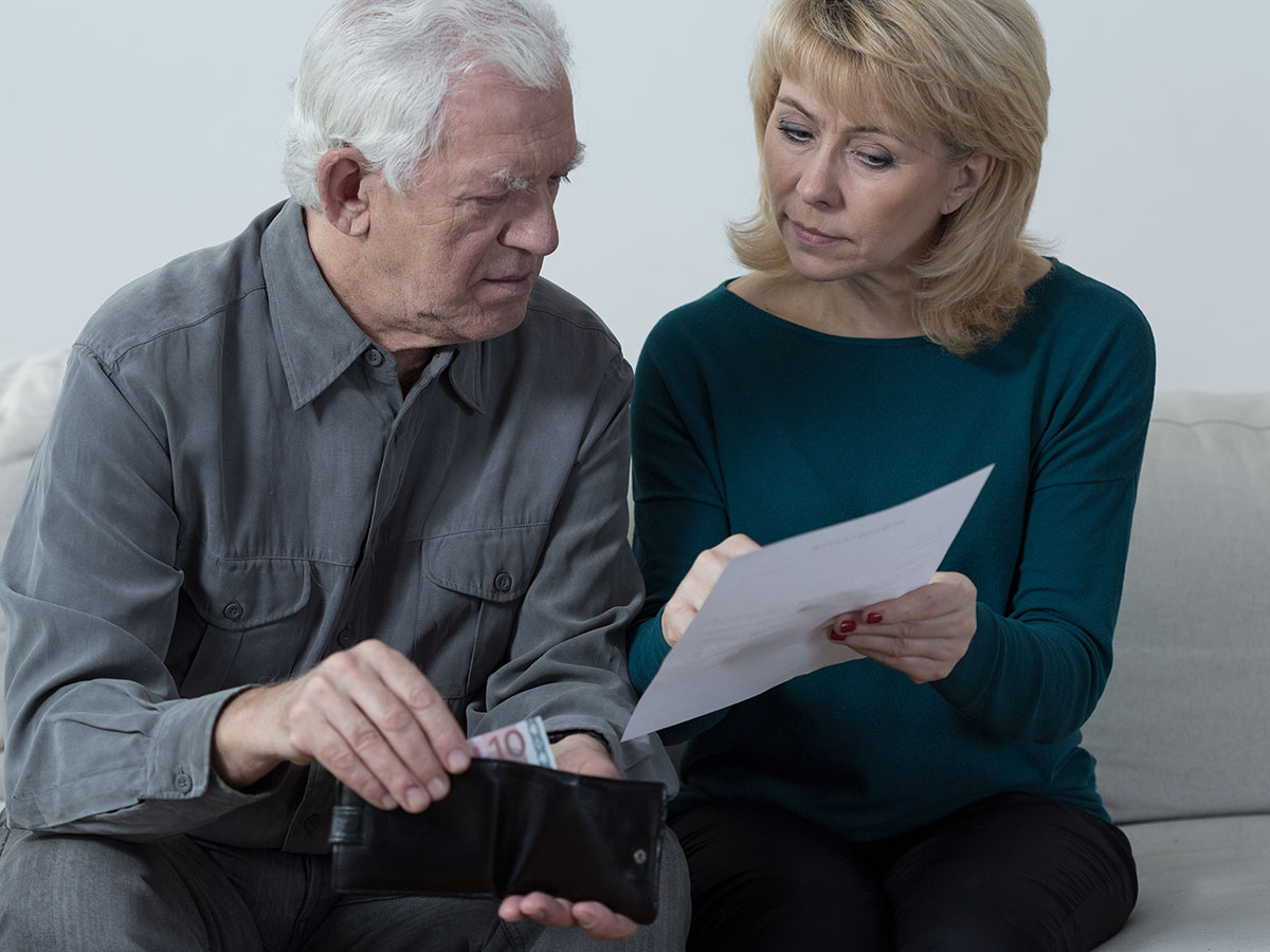Image of a couple looking at fees on a document