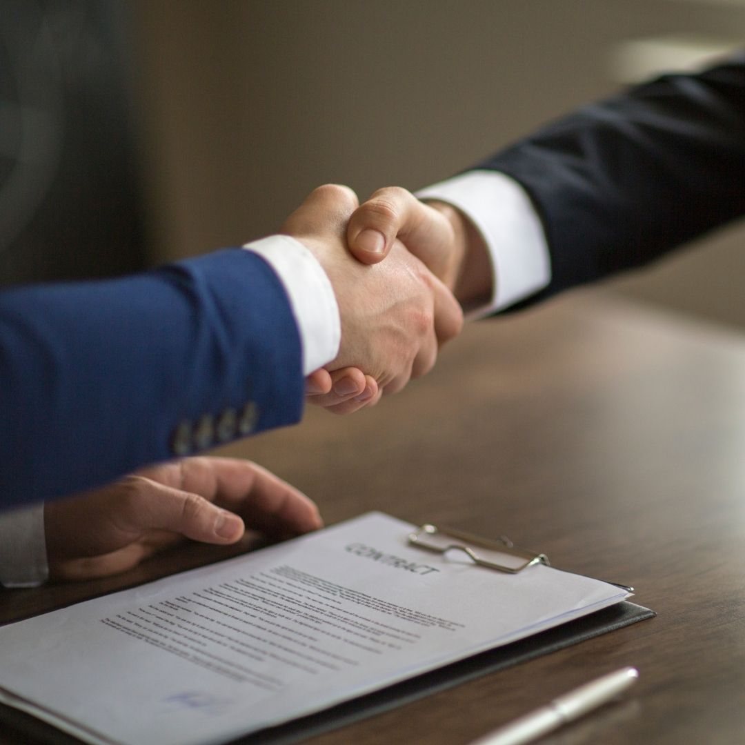 real estate lawyer shaking hands with client